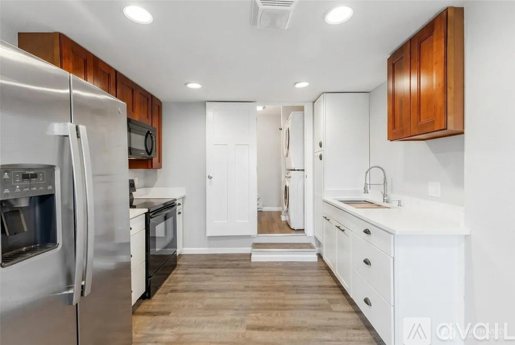 A modern kitchen with wooden cabinets and stainless steel appliances.