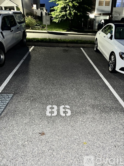 A parking space with the number 86 painted on the pavement.