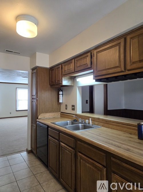 A kitchen with wooden cabinets and a sink.