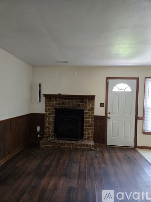 A room with a fireplace and a door.