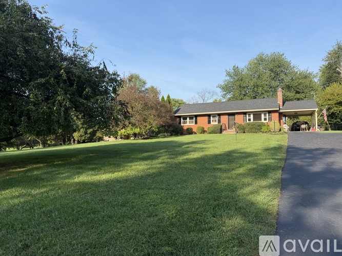 A house with a lawn in front of it is for sale.