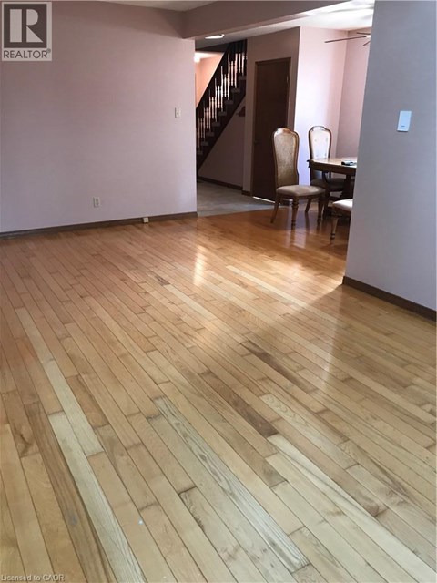 A room with wooden flooring and a chair.