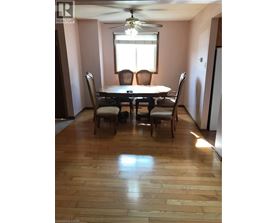 A dining room with a table and chairs.