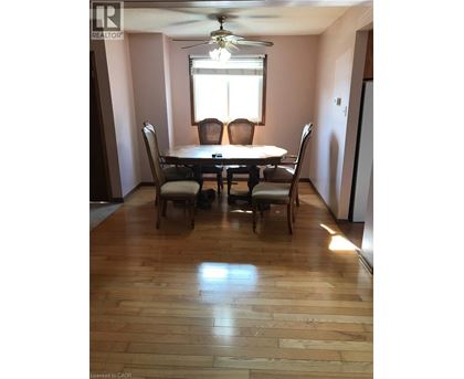 A dining room with a table and chairs.