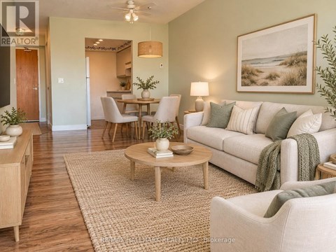 A living room with a couch, chairs, and a coffee table.