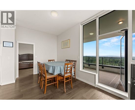 A dining room with a table set for four.