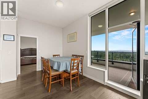 A dining room with a table set for four.