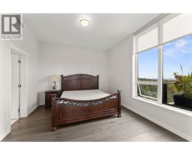 A bedroom with a large bed and a window overlooking the outdoors.