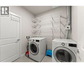 A laundry room with a washer and dryer and a white door.