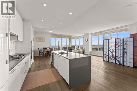 A modern kitchen with white cabinets and a large island.