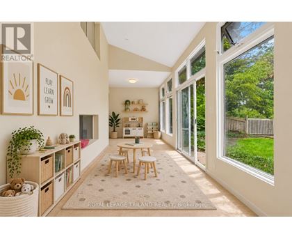 A sunny room with a table and chairs and a window.