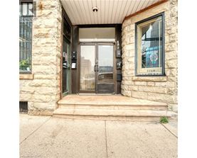 The front door of a building with a glass panel and a sign on the window.