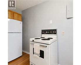 A white stove with a towel hanging on the oven door.