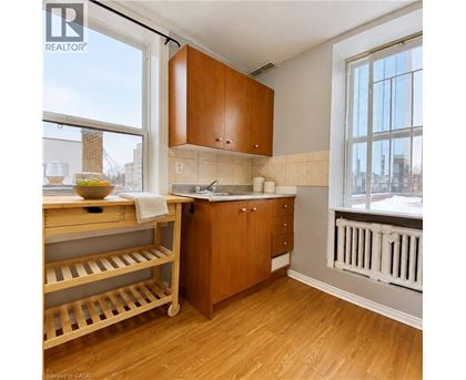 A kitchen with wooden cabinets and a white radiator.