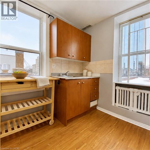 A kitchen with wooden cabinets and a white radiator.