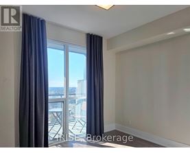 A room with a view of a cityscape through a large window.