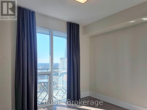 A room with a view of a cityscape through a large window.