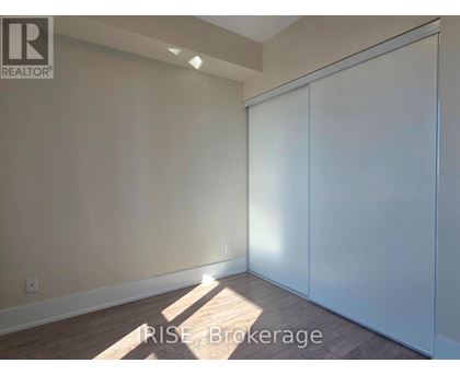 A room with a sliding door and a light on the wall.