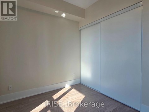 A room with a sliding door and a light on the wall.