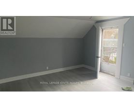 A room with a door leading to a balcony.