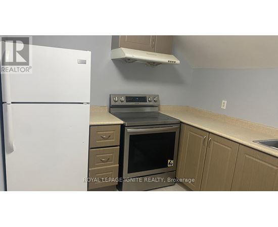 A kitchen with a white fridge, a stove and a microwave.