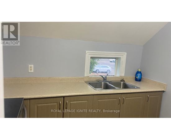 A kitchen with a sink and a window.