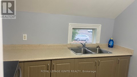 A kitchen with a sink and a window.