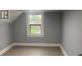 A room with a window and a logo on the wall.
