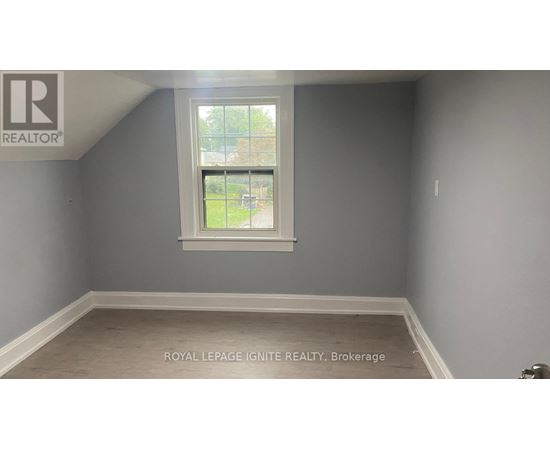 A room with a window and a logo on the wall.