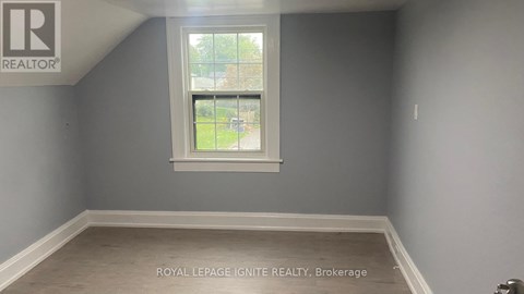 A room with a window and a logo on the wall.