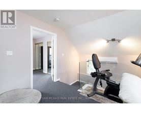 A room with a gym equipment and a bed.