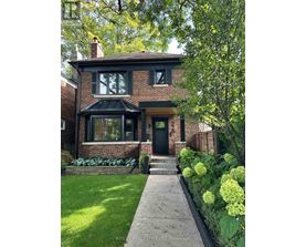 A house with a green lawn and a black door.
