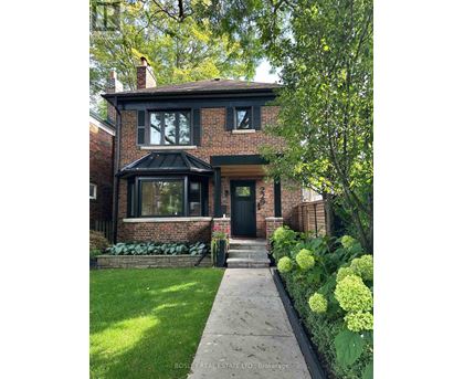 A house with a green lawn and a black door.
