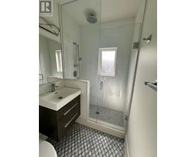 A bathroom with a sink, toilet, and shower.