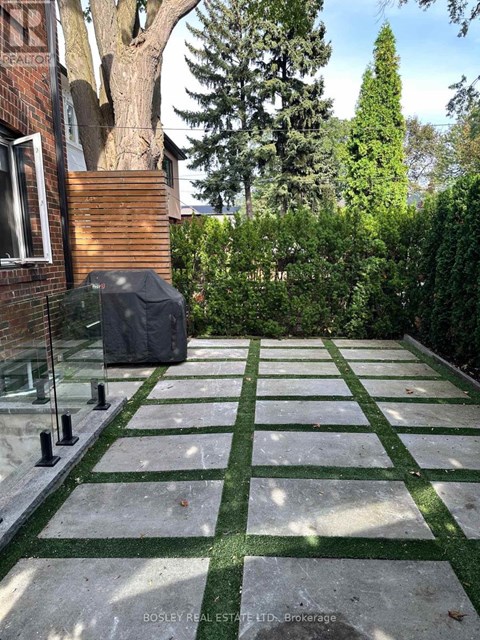 A garden with a green lawn and a stone pathway.