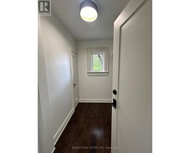 A hallway with a skylight and a door on the right.
