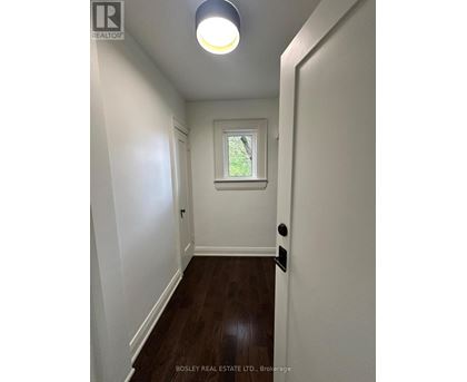 A hallway with a skylight and a door on the right.