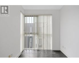 A room with a sliding door leading to a balcony.