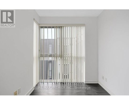 A room with a sliding door leading to a balcony.