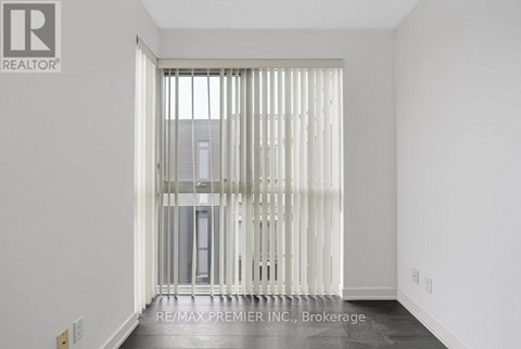 A room with a sliding door leading to a balcony.