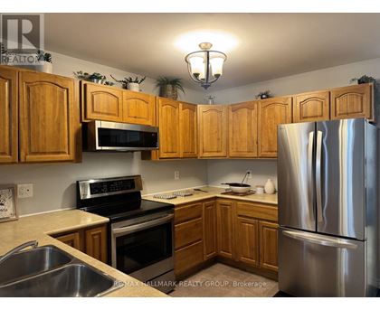 A kitchen with wooden cabinets and stainless steel appliances.
