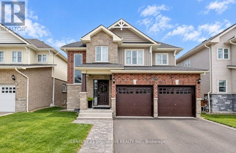 A large, well-maintained house with a brick facade and a large front yard.