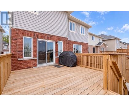 A wooden deck with a black tarp on it.
