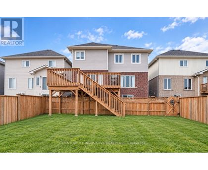 A real estate company is showcasing a beautiful home with a large backyard and a deck.