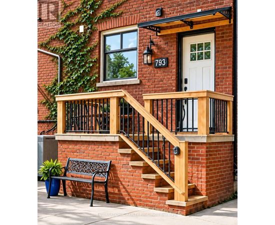 A red brick house with a white door and a black railing on the stairs.