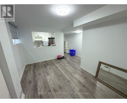 A room with a wooden floor and a mirror on the wall.
