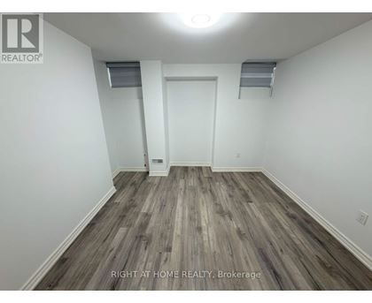 A room with wood flooring and white walls.