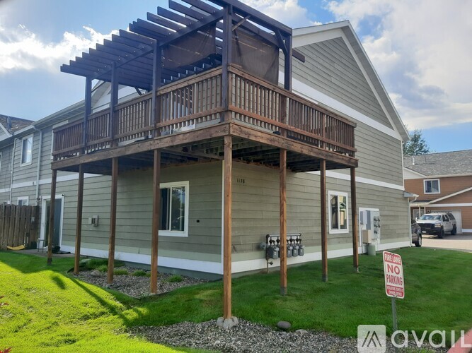 A house with a balcony and a "No Parking" sign in front.