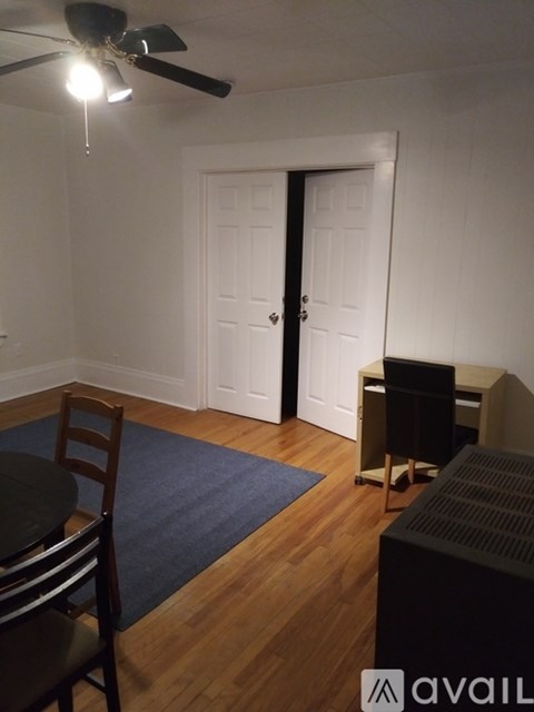 A room with a ceiling fan and a closed door.