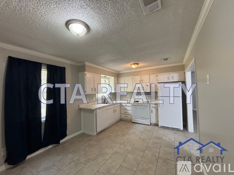 A kitchen area with a CTA Realty logo superimposed on the image.